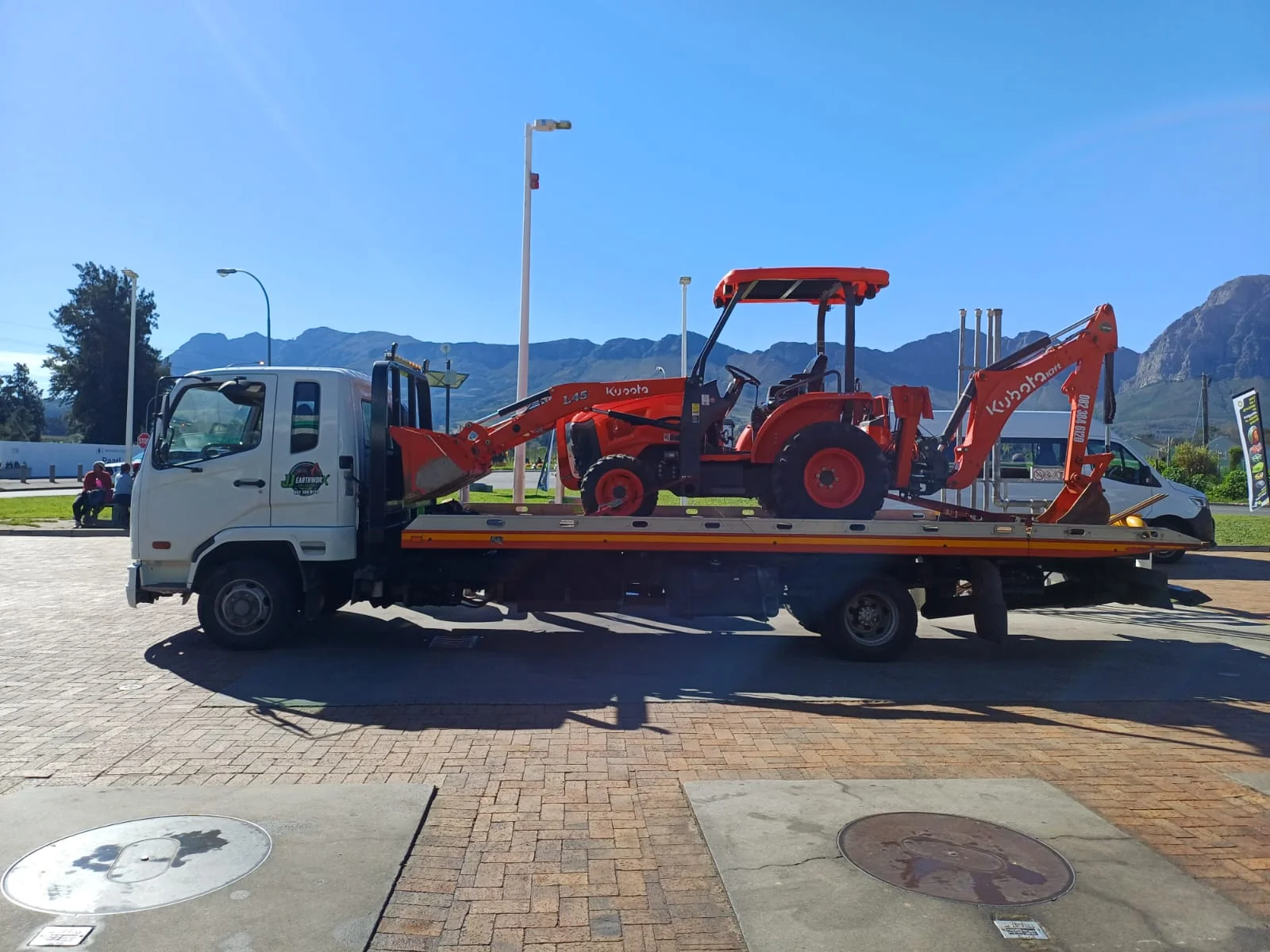 Controlled demolition of a concrete structure using heavy machinery